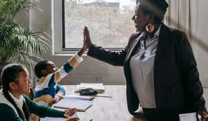 Teacher encouraging young students in their classroom