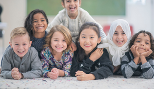 Diverse students pose for a picture in a classroom